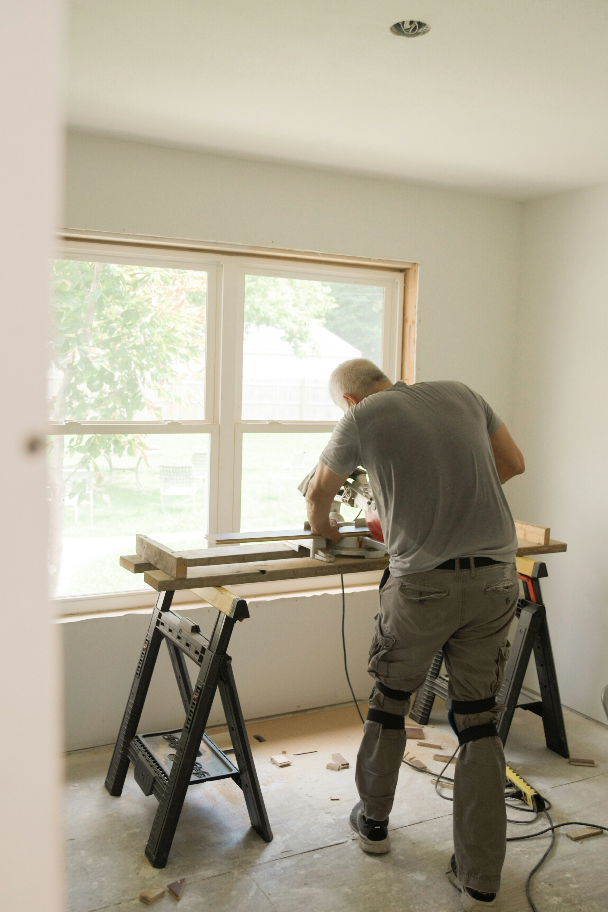 Skilled craftsman cutting trim during a residential home renovation — Diodato Construction